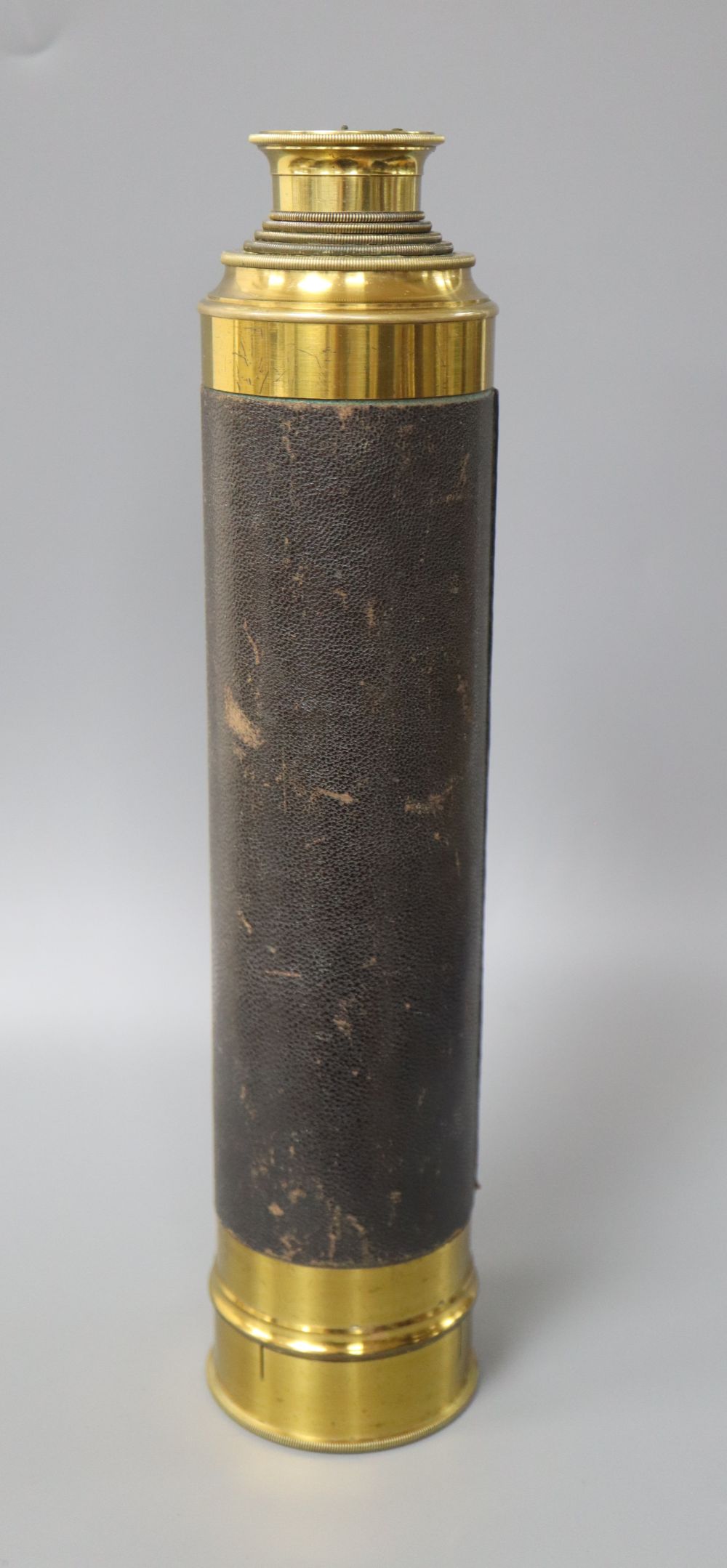 A boxed four drawer brass and leather telescope